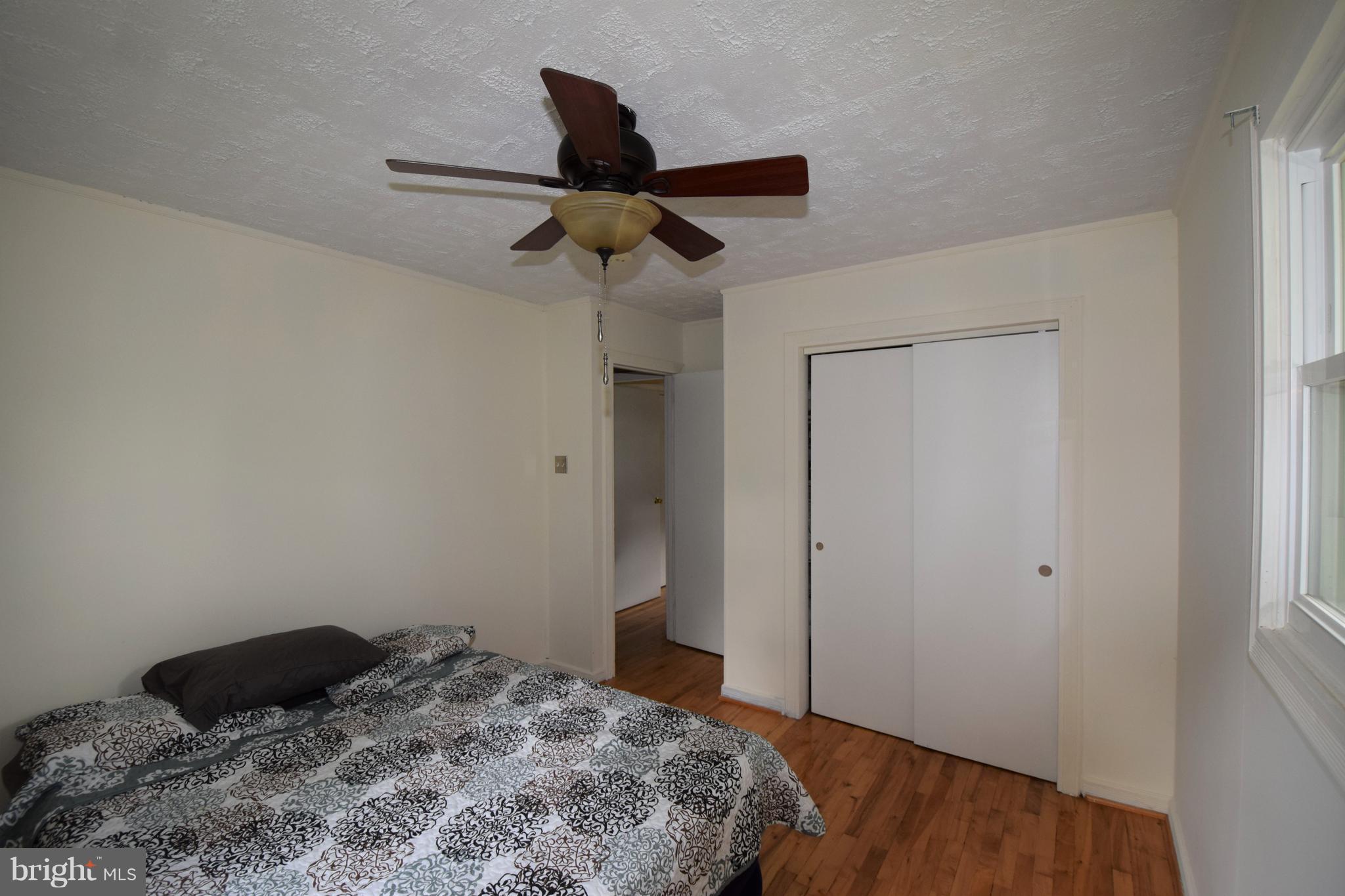4836 Teen Barnes Road Frederick, MD 21703 - Photo 21 of 29 a bedroom with a bed and a ceiling fan