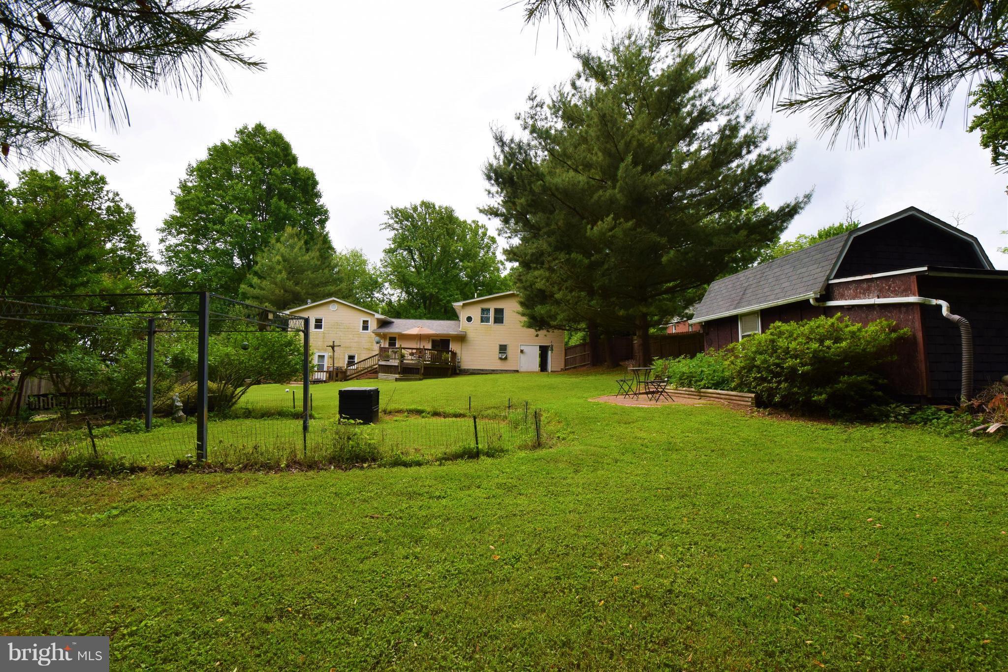 4836 Teen Barnes Road Frederick, MD 21703 - Photo 28 of 29 a view of a house with a big yard and potted plants and large trees