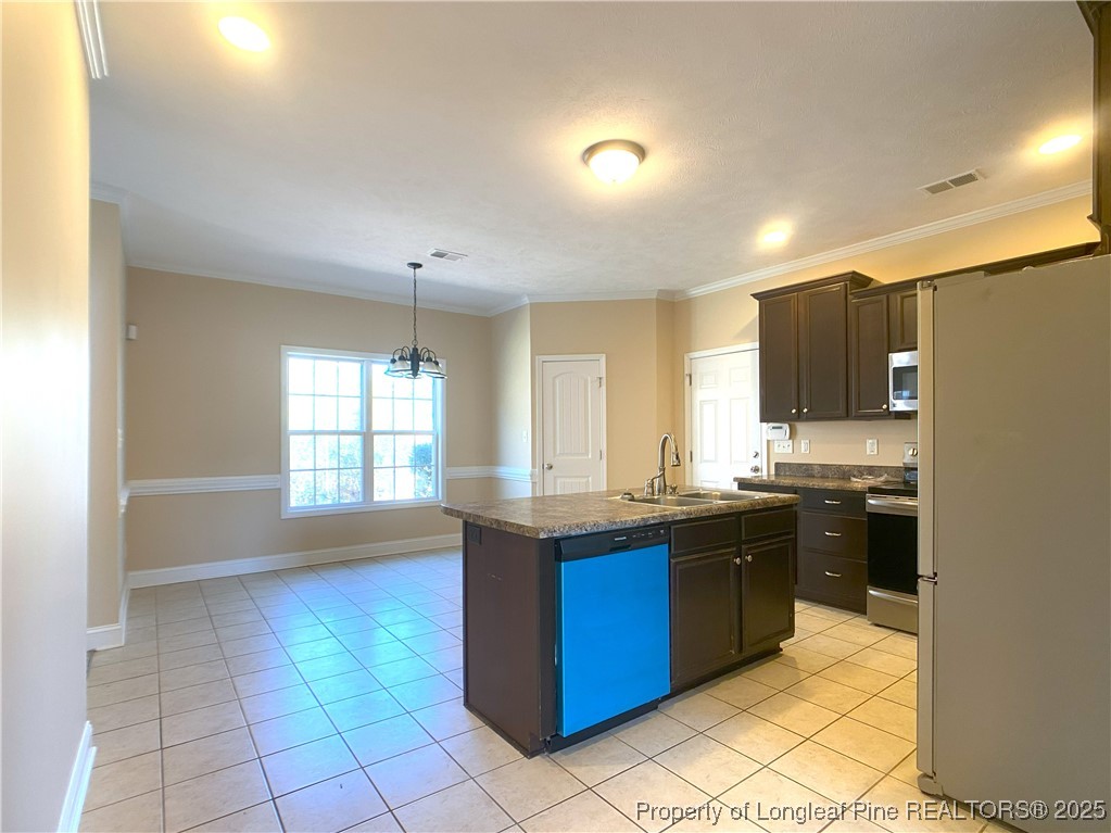 401 Regimental Drive Cameron, NC 28326 - Photo 11 of 35 a kitchen with stainless steel appliances granite countertop a stove a sink dishwasher and a refrigerator
