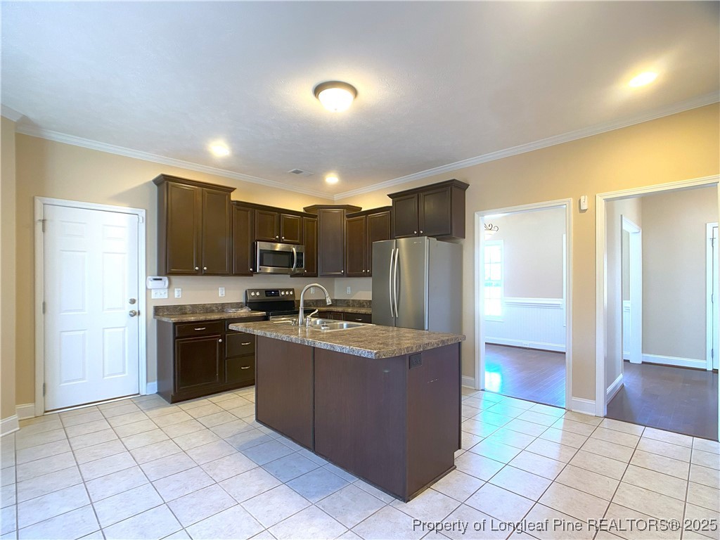 401 Regimental Drive Cameron, NC 28326 - Photo 12 of 35 a kitchen with stainless steel appliances granite countertop a refrigerator a stove top oven and a sink