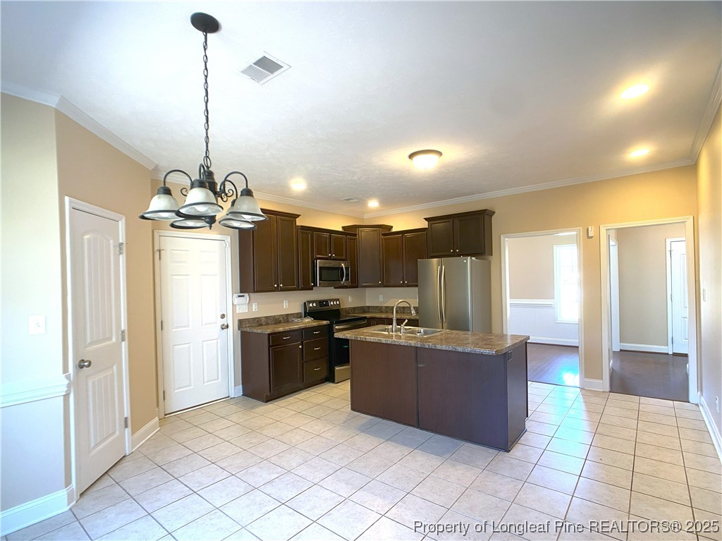 401 Regimental Drive Cameron, NC 28326 - Photo 14 of 35 a view of a kitchen with kitchen island granite countertop a refrigerator a stove top oven and a sink