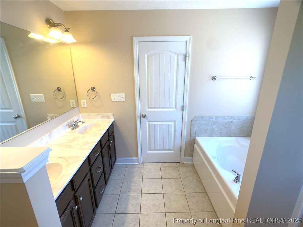 401 Regimental Drive Cameron, NC 28326 - Photo 23 of 35 a bathroom with a tub sink and mirror
