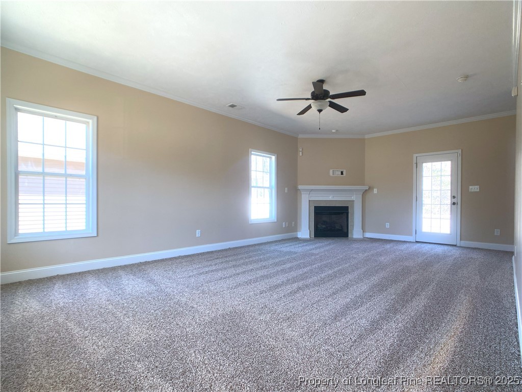401 Regimental Drive Cameron, NC 28326 - Photo 6 of 35 an empty room with windows and fireplace