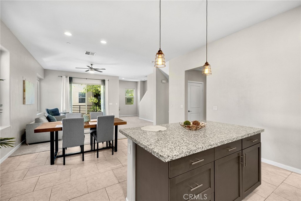746 Farrier Way Upland, CA 91786 - Photo 11 of 45 a kitchen with granite countertop sink table and chairs