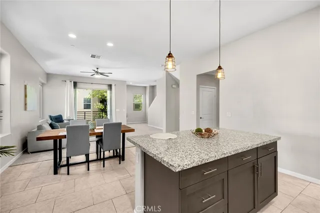 a kitchen with granite countertop sink table and chairs