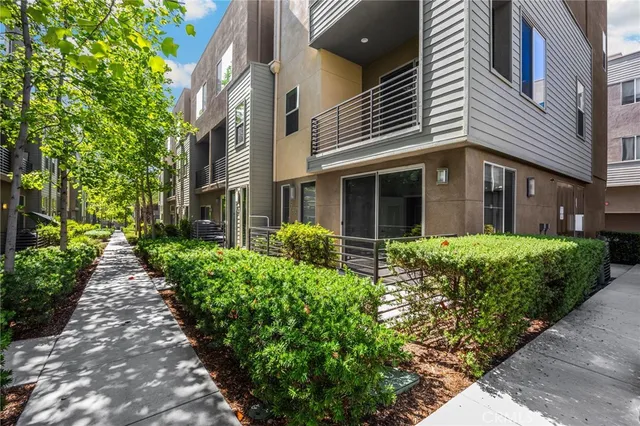 a view of a house with a yard and pathway