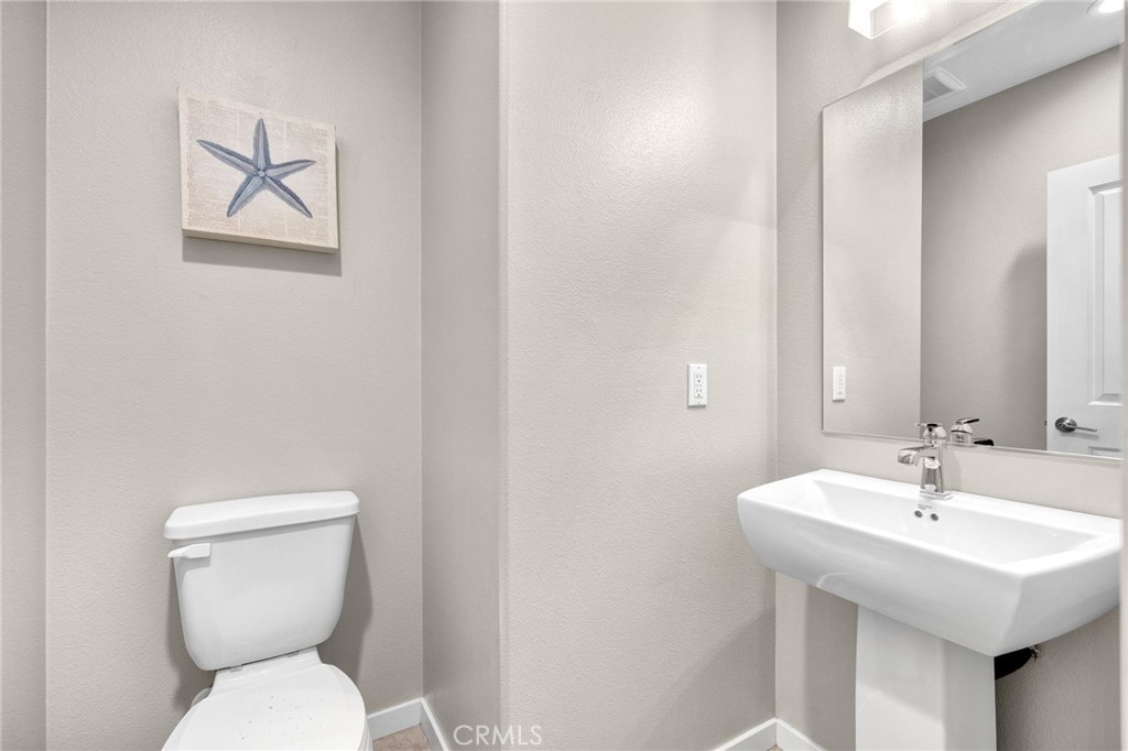 746 Farrier Way Upland, CA 91786 - Photo 28 of 45 a bathroom with a toilet sink and mirror