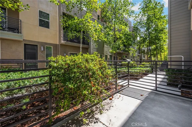 a view of a pathway both side of the house