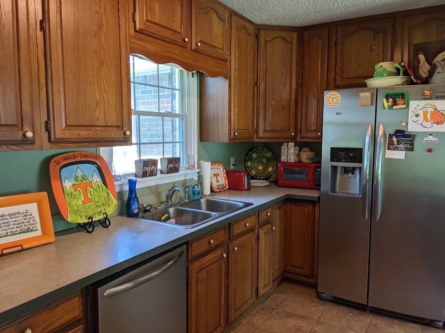 6 Power Station Road Taft, TN 38488 - Photo 16 of 29 a kitchen with stainless steel appliances wooden cabinets a sink and a refrigerator