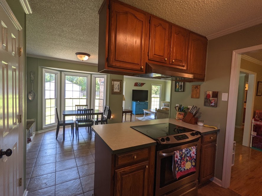 6 Power Station Road Taft, TN 38488 - Photo 17 of 29 a kitchen with a stove a refrigerator and dining table