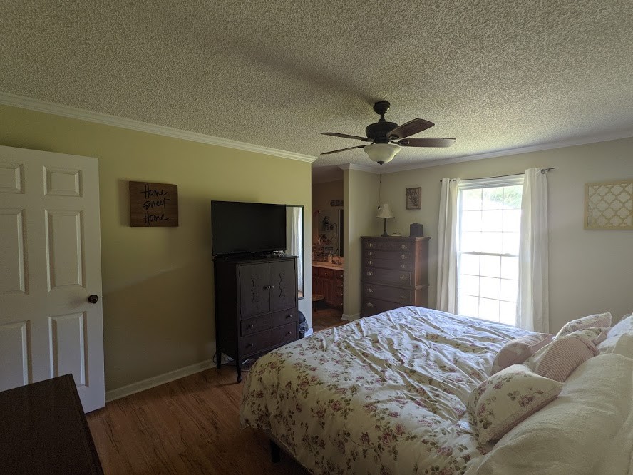 6 Power Station Road Taft, TN 38488 - Photo 21 of 29 a bed sitting in a bedroom and a flat tv screen in a bedroom