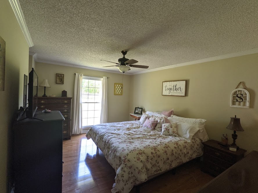 6 Power Station Road Taft, TN 38488 - Photo 22 of 29 a bedroom with a bed and a chandelier