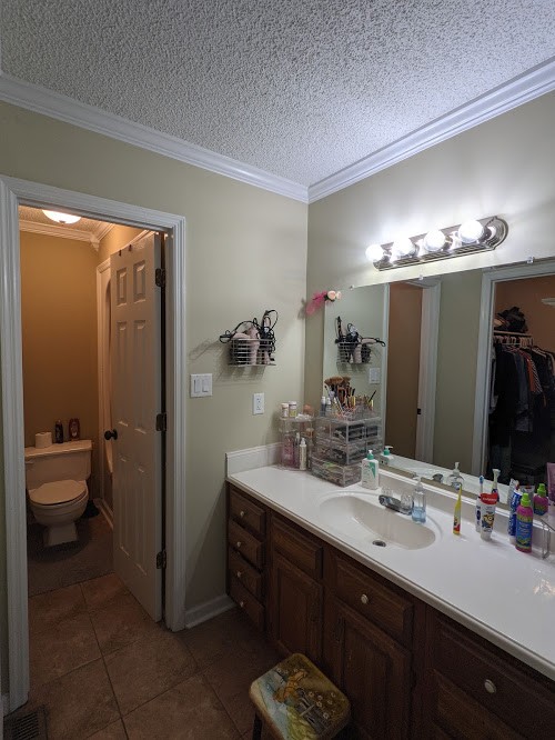 6 Power Station Road Taft, TN 38488 - Photo 23 of 29 a bathroom with a double vanity sink a toilet a mirror and shower