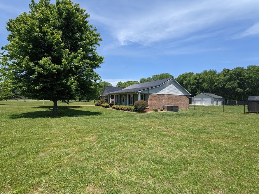 6 Power Station Road Taft, TN 38488 - Photo 5 of 29 a front view of a house with a yard
