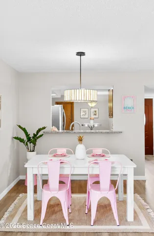a view of dining room with furniture and wooden floor