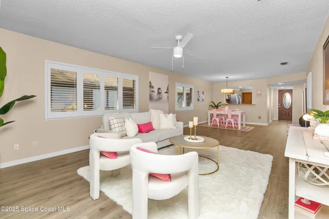 a living room with furniture and wooden floor