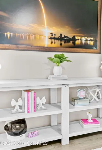 a utility room with lots of clutter and cabinets