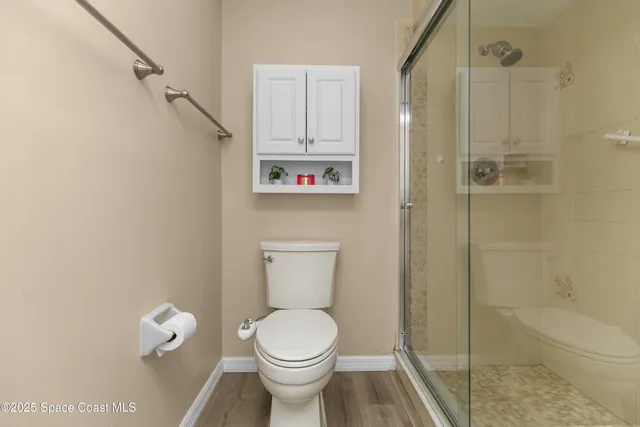 a bathroom with a toilet and a shower