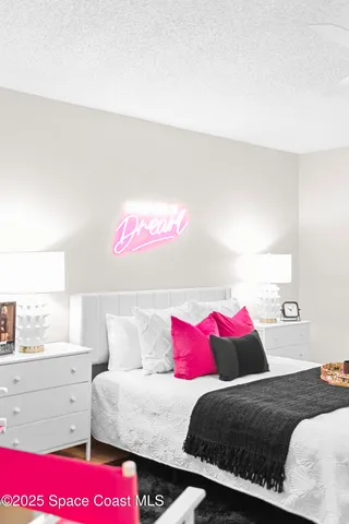 a bedroom with a bed and a dresser