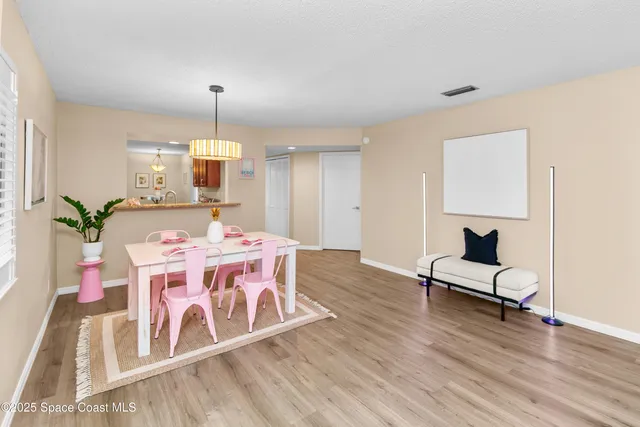 a living room with kitchen island furniture and a chandelier