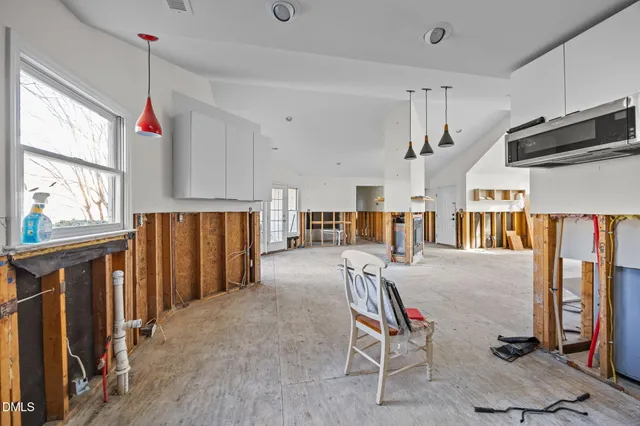 a living room with furniture a flat screen tv and a window