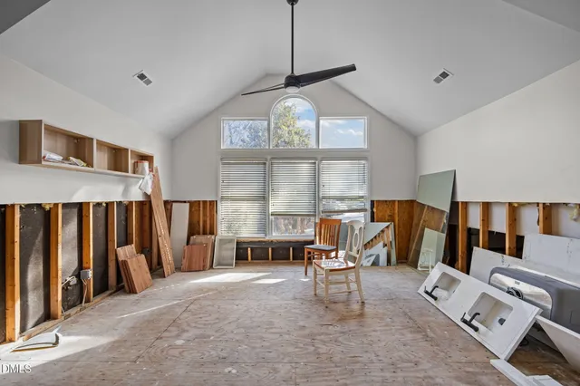 a living room with furniture a fireplace and a large window