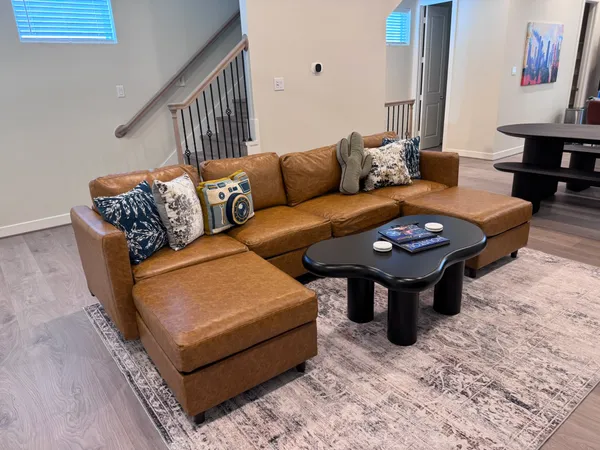 a living room with furniture a rug and a window