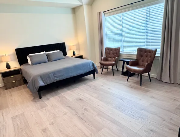 a living room with a flat screen tv and dresser