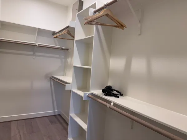 a large bed sitting in a bedroom next to a window