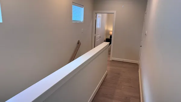 a view of a hallway with staircase