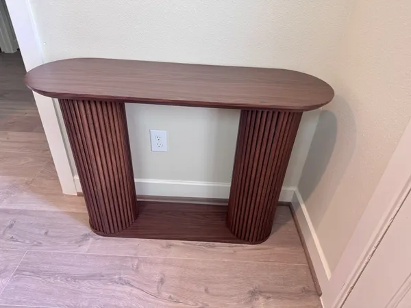 a bed sitting in a bedroom next to a window and a sink