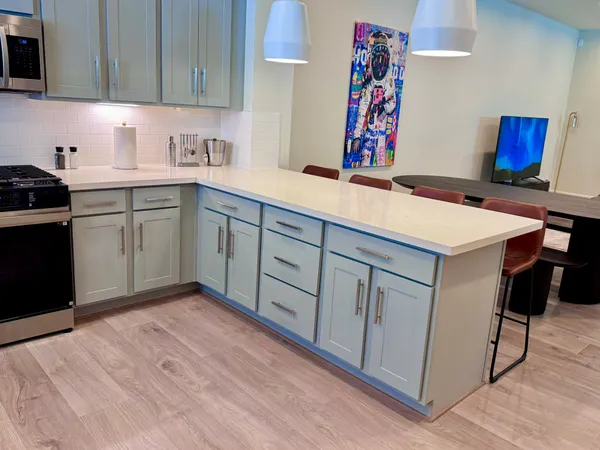 a kitchen with stainless steel appliances granite countertop a sink dishwasher stove and cabinets