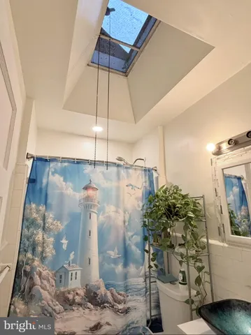 a bathroom with a toilet and shower