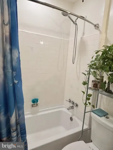 a bathroom with a shower and a tub