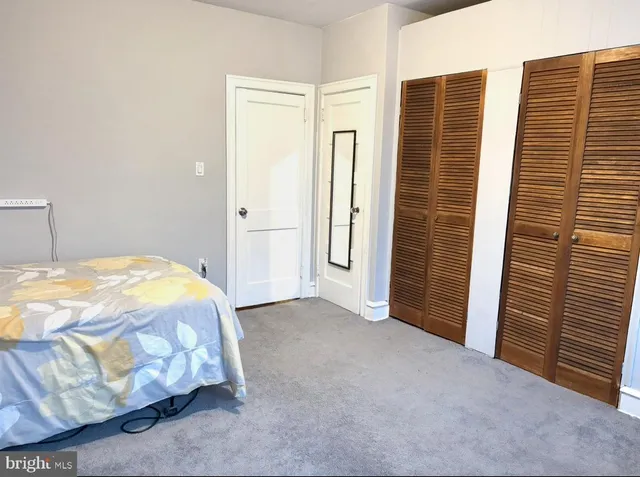 a bedroom with a bed and a mirror