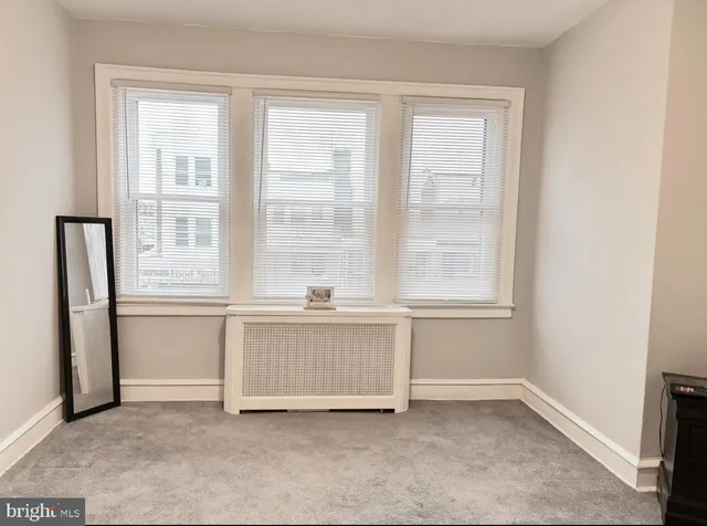 a room with window and cabinet