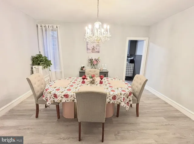 a view of a dining room with furniture and chandelier