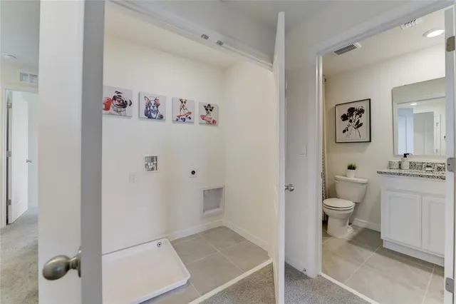 a bathroom with a granite countertop sink a toilet and a shower