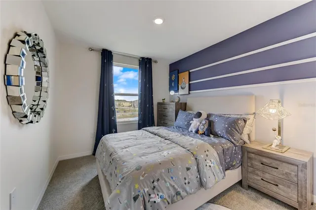 a bedroom with a large bed and a window