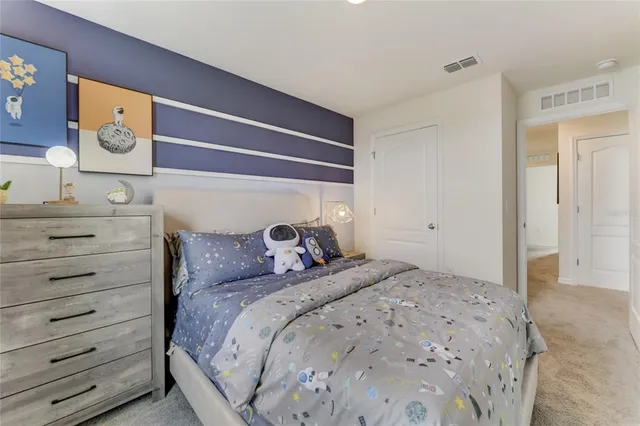 a bedroom with a bed and a mirror