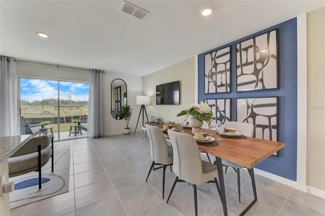 a view of a dining room with furniture large windows and wooden floor