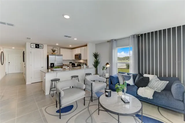a living room with furniture kitchen view and a table