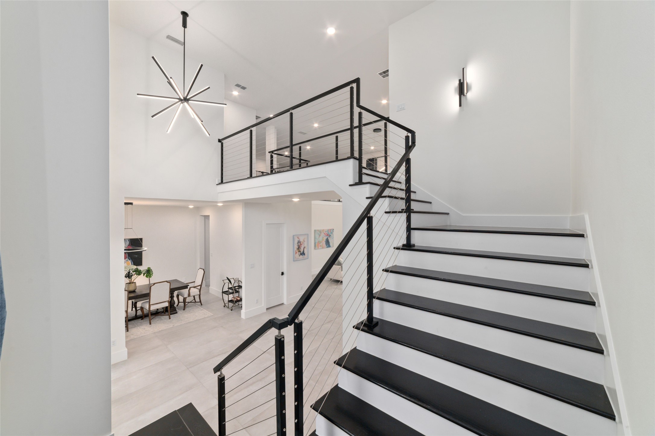 29627 Cir S Rnch Trail Fulshear, TX 77406 - Photo 10 of 50 The floating staircase isn't simply functional. It's one of the home's defining architectural moments, creating a stunning focal point from nearly every angle.