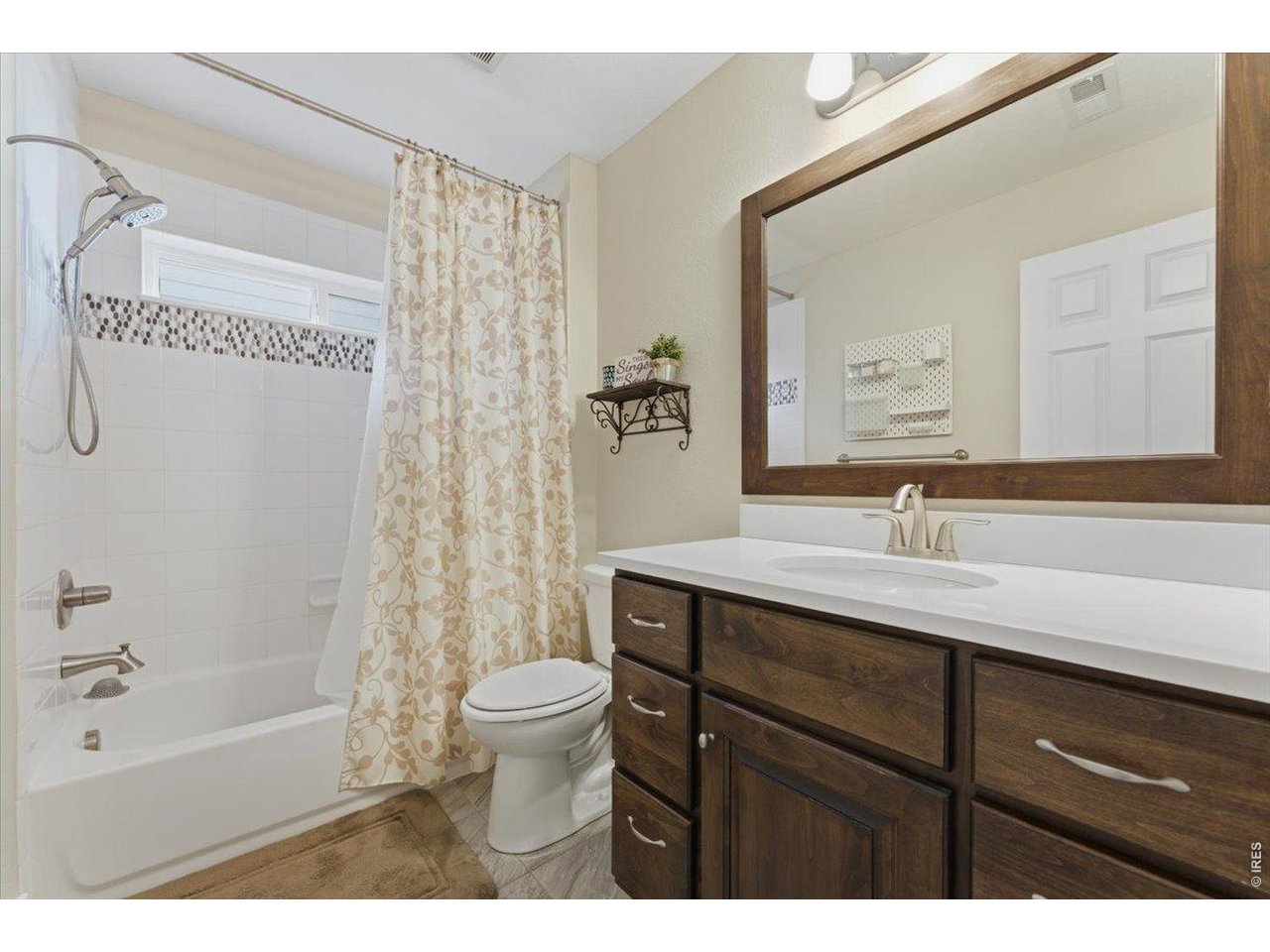 1148 Wagon Bend Road Berthoud, CO 80513 - Photo 26 of 50 a bathroom with a sink a toilet a mirror a bathtub and shower