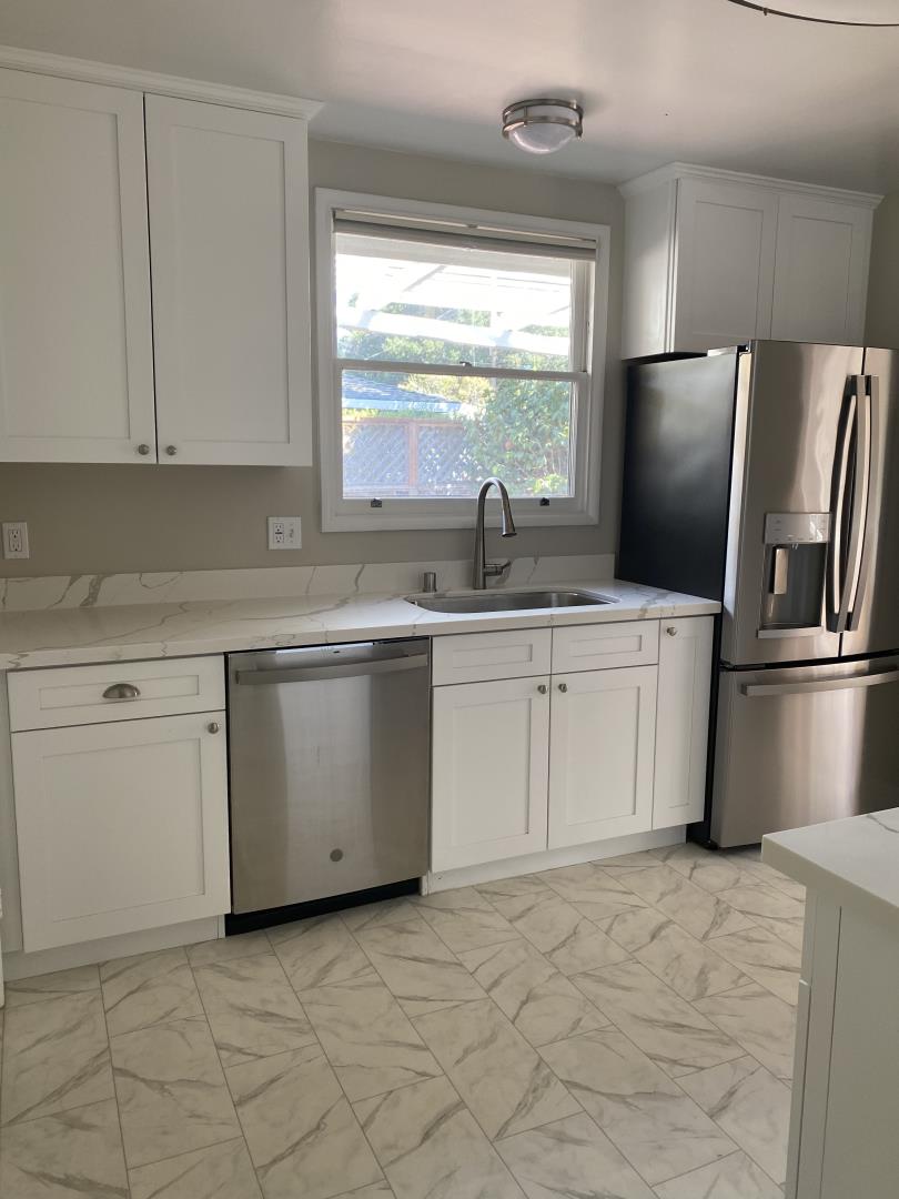 139 Louise Lane San Mateo, CA 94403 - Photo 7 of 11 a kitchen with white cabinets appliances a sink and a window