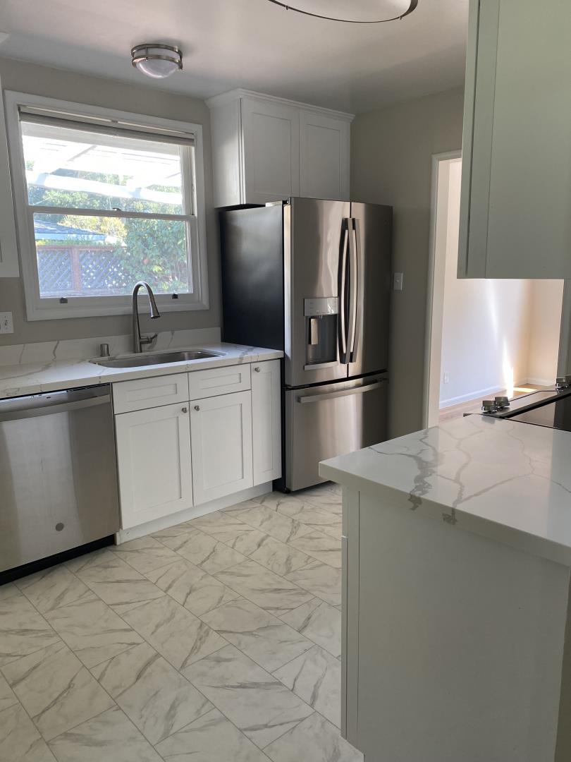 139 Louise Lane San Mateo, CA 94403 - Photo 8 of 11 a kitchen with stainless steel appliances granite countertop a sink stove and refrigerator