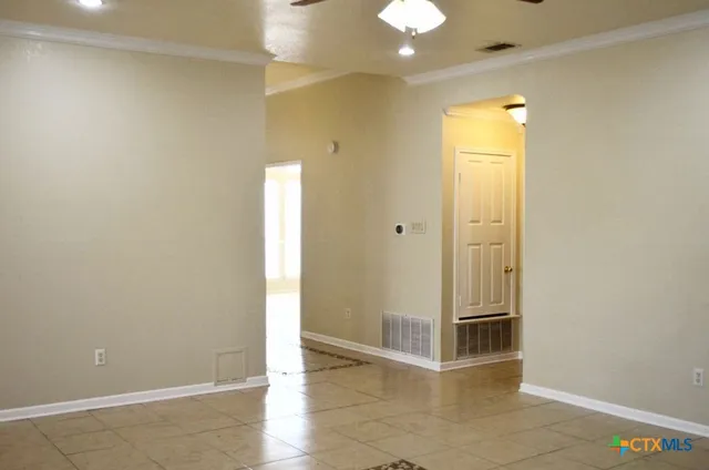 an empty room with windows and cabinet