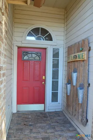 a view of a hallway with wooden shelves