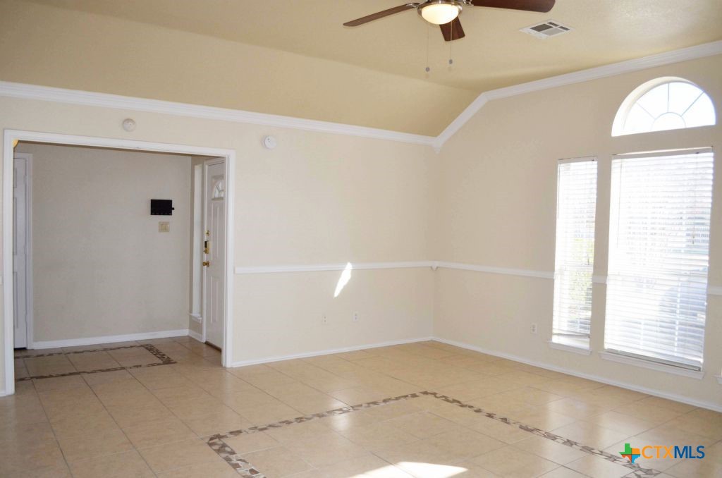 4411 Kit Carson Trail Killeen, TX 76542 - Photo 7 of 45 an empty room with a windows and ceiling fan