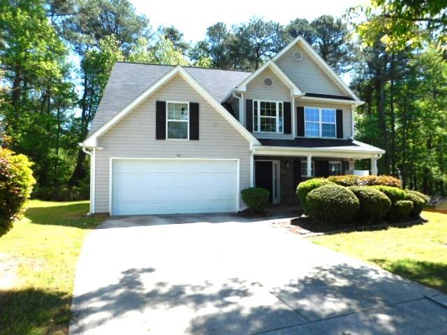 1834 Stephens Pond View Loganville, GA 30052 - Photo 1 of 25 a front view of a house with a yard and garage